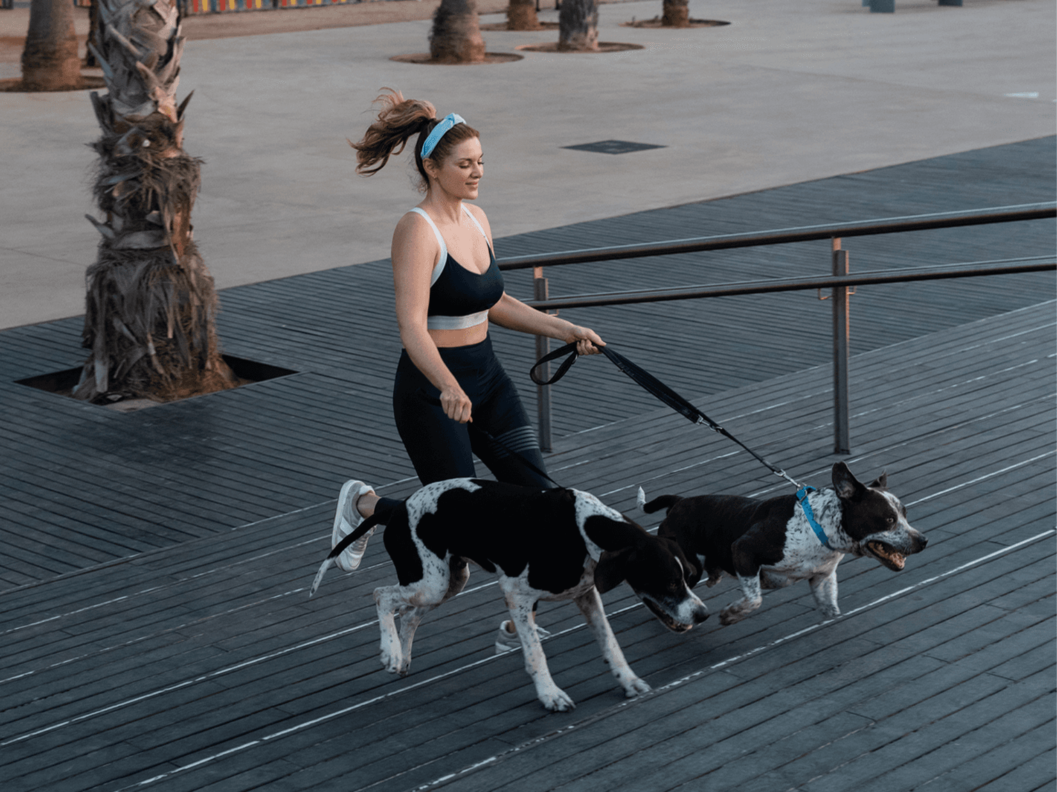 woman running with mixed breed dog