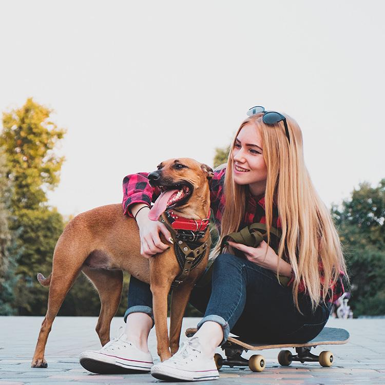 Woman on skateboard with rescue dog